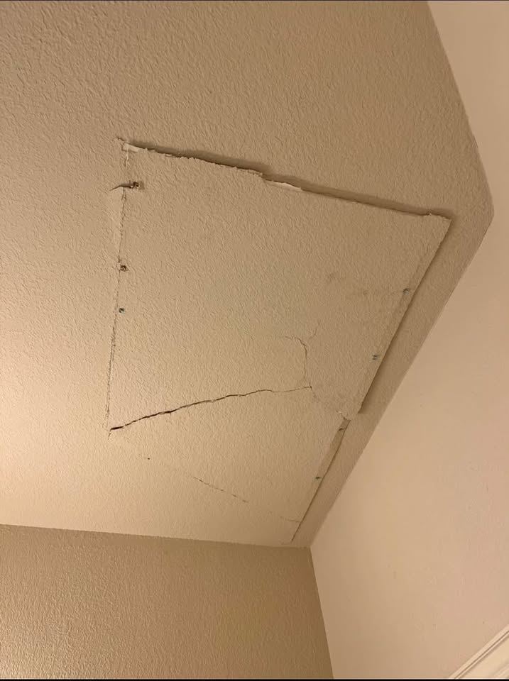 Cracked ceiling patch panel screwed in but unfinished