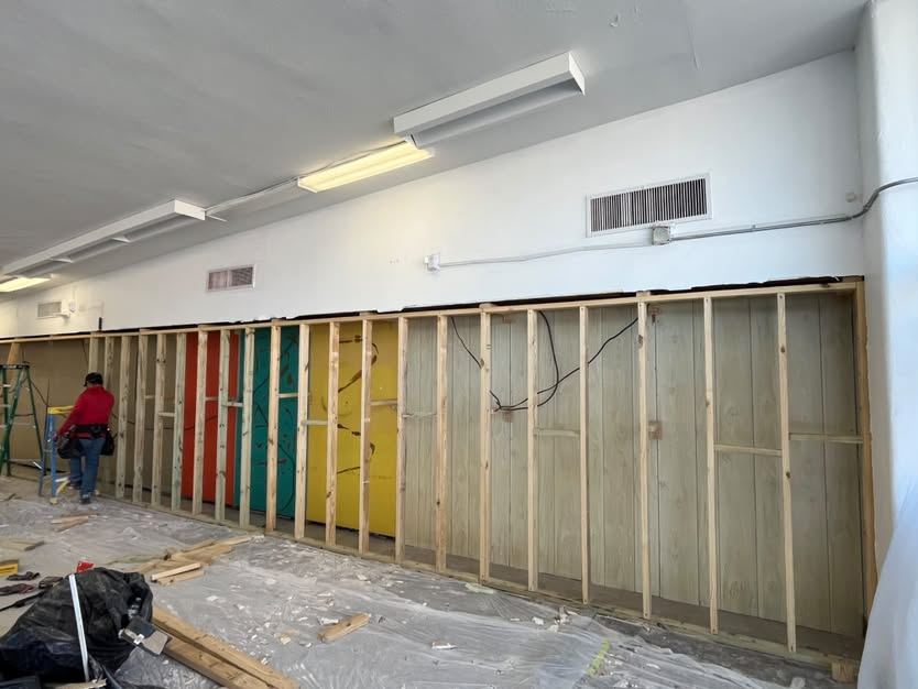 Commercial wall stripped to the framing along the full run