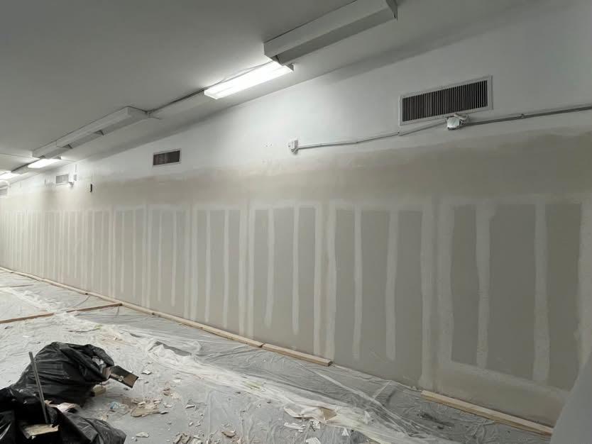 The same run hung with new drywall, taped and floated