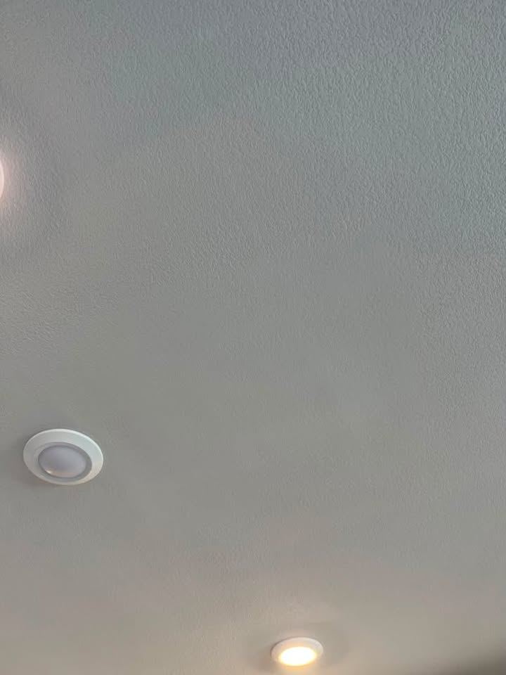 Smooth finished knockdown textured ceiling with recessed lights