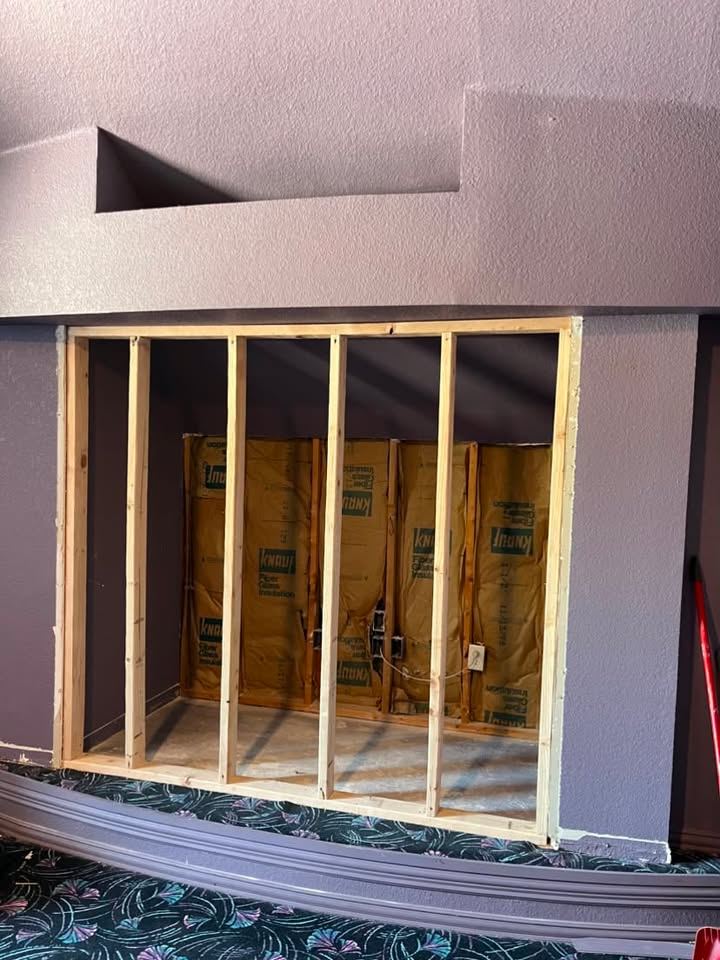 Framed wall opening with insulation before drywall
