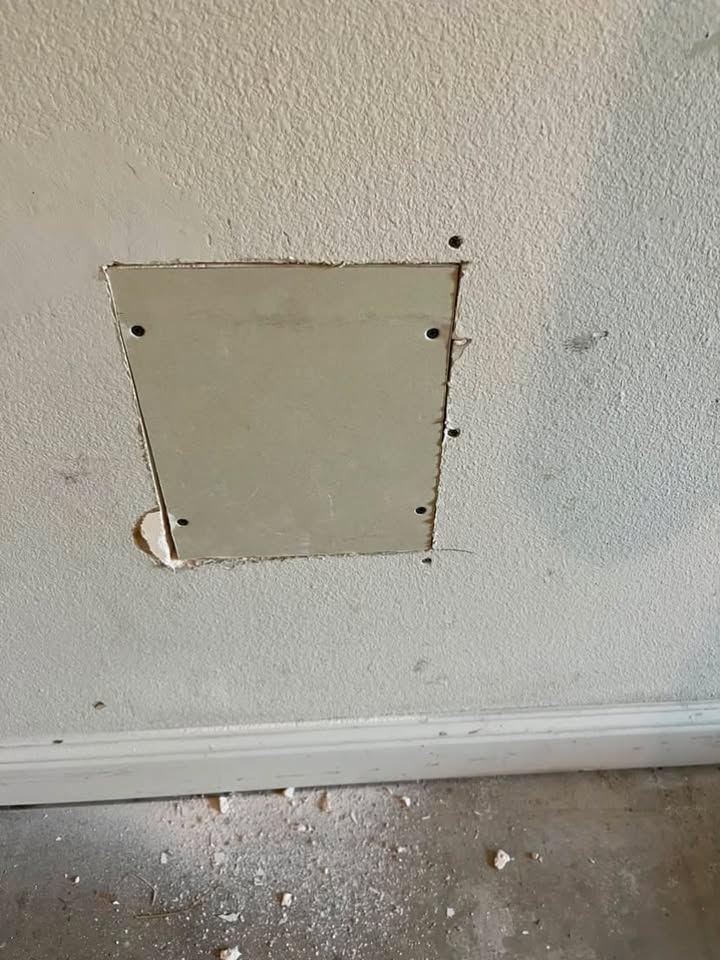Drywall patch screwed into the opening, joints still exposed
